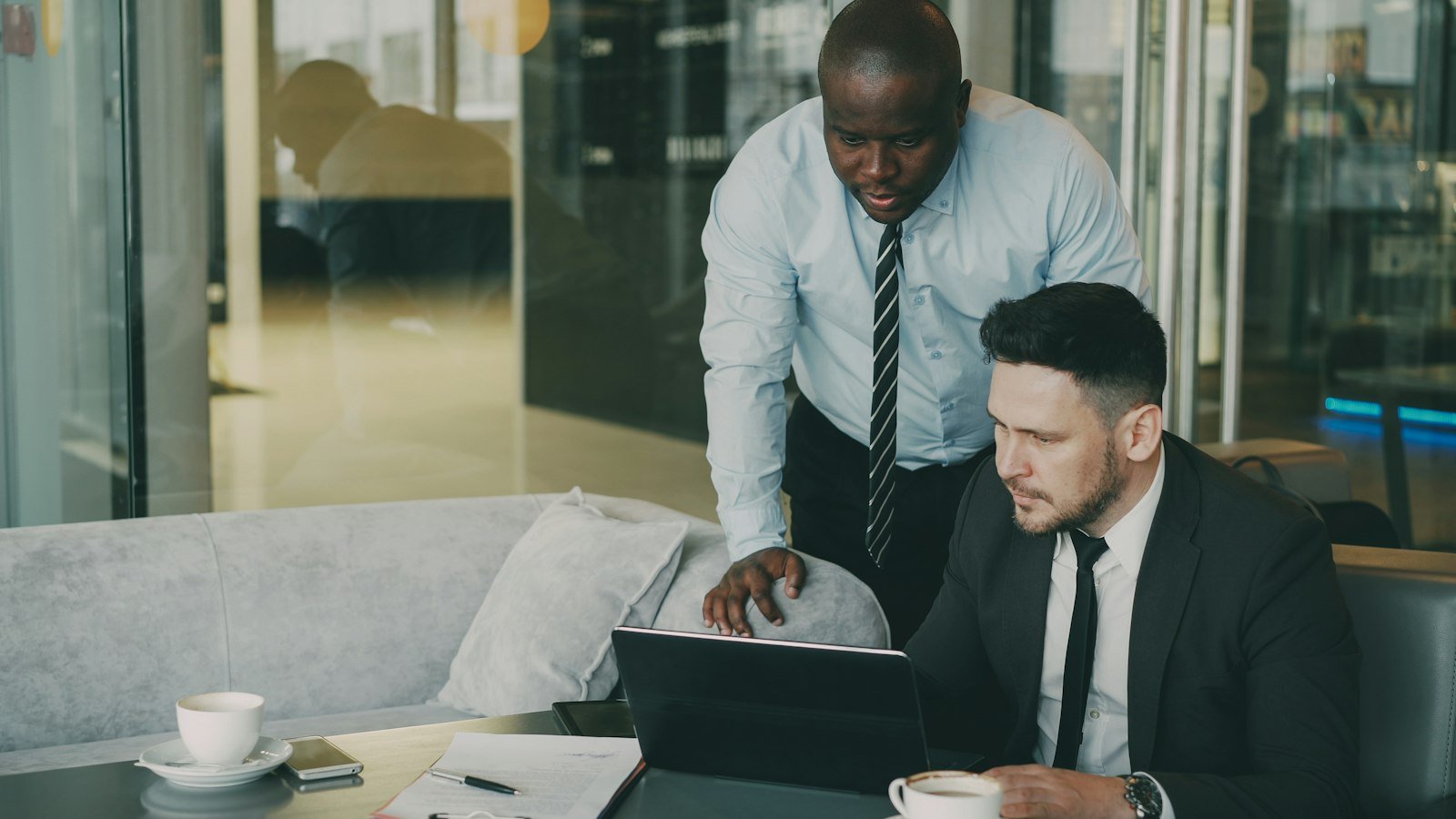 Two business colleagues reviewing information together on a laptop.